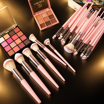 Brushes with eyeshadow palettes on black and gold
